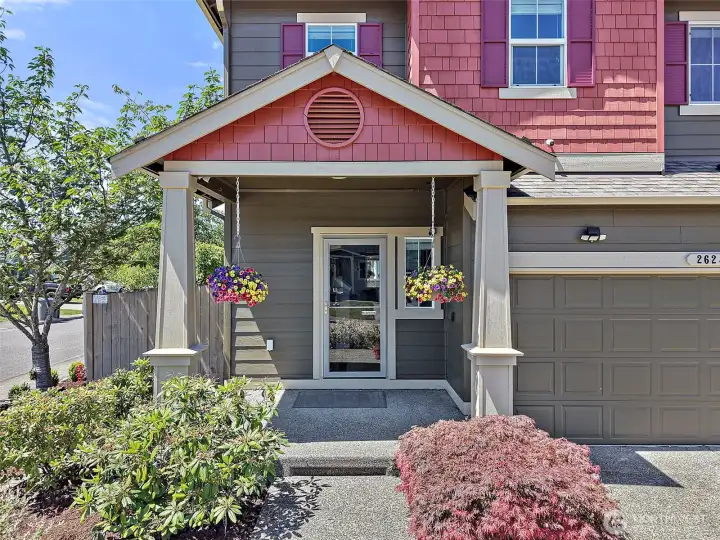 Move-In Ready Two-Story Home on a Desirable Corner Lot with Charming Curb Appeal, Covered Front Porch, Low-Maintenance Landscaping, and Attached Garage in the Heart of Maple Valley.