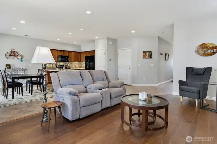 Bright and inviting living room featuring a cozy gas fireplace, abundant natural light, and an open layout designed for comfortable everyday living and entertaining.