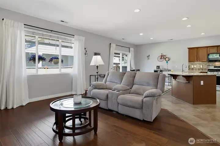 Bright and inviting living room featuring a cozy gas fireplace, abundant natural light, and an open layout designed for comfortable everyday living and entertaining.
