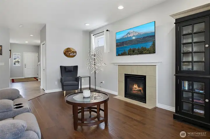 Bright and inviting living room featuring a cozy gas fireplace, abundant natural light, and an open layout designed for comfortable everyday living and entertaining.