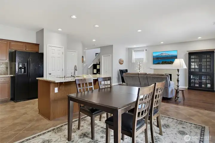 Open-concept kitchen, dining, and living areas create a seamless flow for everyday living, entertaining, and gathering around the cozy gas fireplace.
