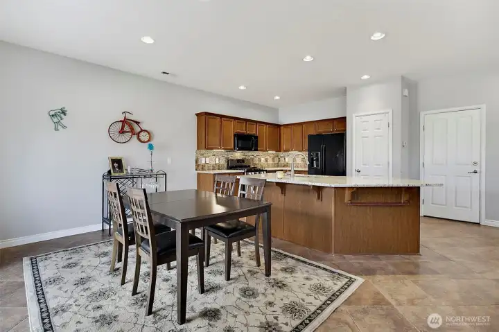 Open-concept kitchen and dining area with granite countertops, center island, and everyday functionality.