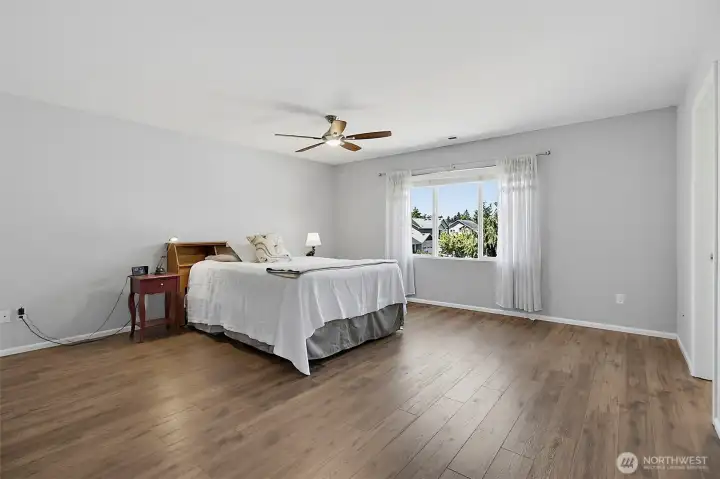 Bright and versatile secondary bedroom featuring abundant natural light, durable flooring.