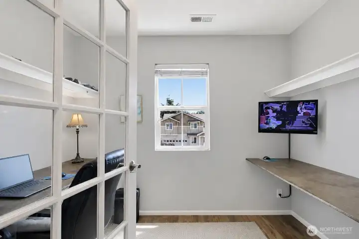Dedicated upstairs den/office provides the perfect space for remote work, studying, creative projects, or a private retreat with abundant natural light.