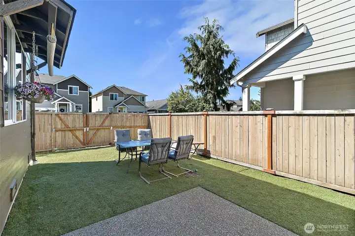 Low-maintenance backyard designed for relaxation and entertaining, featuring astro turf, hot tub, outdoor seating area, storage shed, and plenty of space to enjoy outdoor living with minimal upkeep.