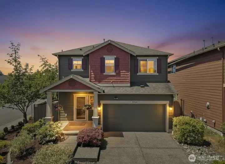 Evening exterior highlighting curb appeal, covered entry, and welcoming presence.