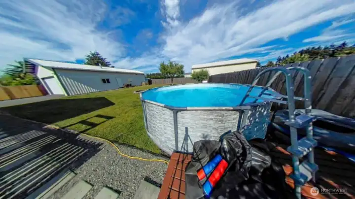 Large back yard with pool and firepit