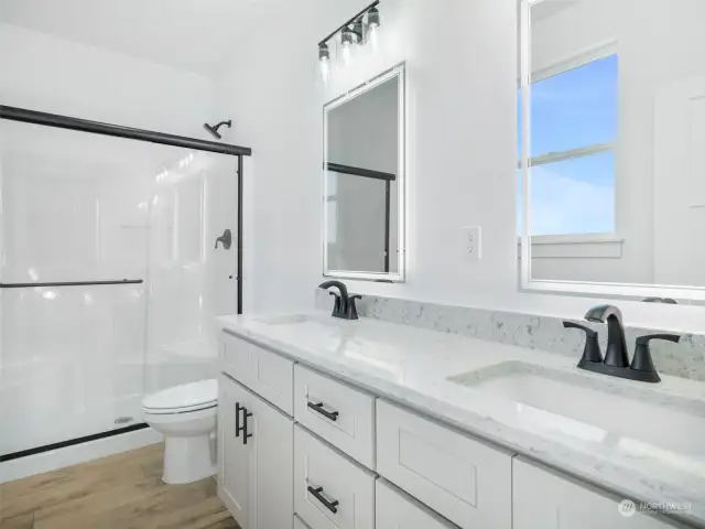 Primary bathroom with granite countertops and double sinks.