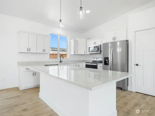 Huge kitchen island with granite.