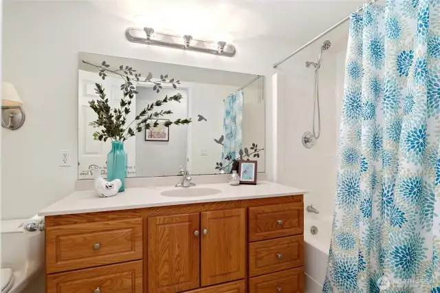Hallway bathroom with a tub.