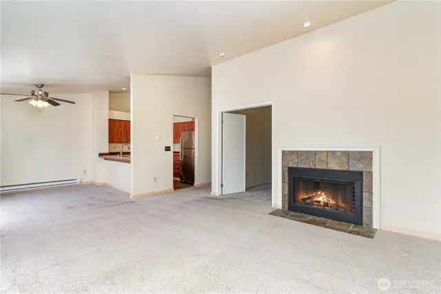 The living room offers the perfect ambiance with the natural light and the cozy fireplace.