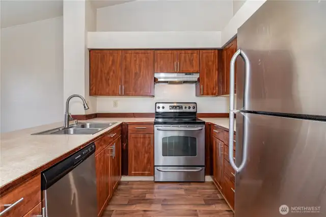 Warm cabinetry, sleek countertops, plenty of storage & all stainless steel appliances stay.
