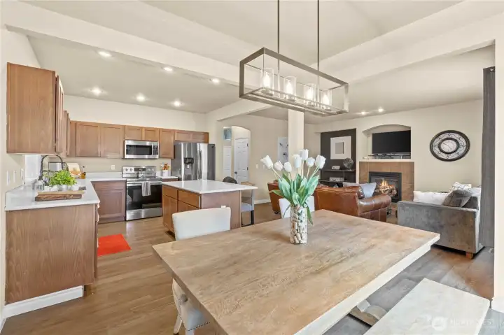 Dining area is tucked to the side but still part of the action