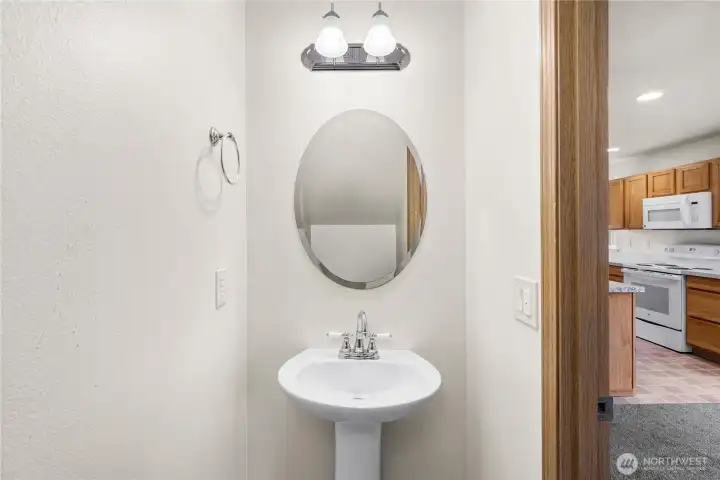 Powder room with automatic lighting and pedestal sink