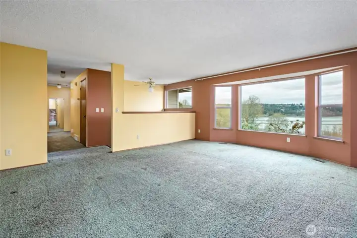 Windows let in lots of light.  Home looks out over Skagit Bay. Island and mountain views. Hallway leads to Main Bath ,2 bedrooms and the Primary Bedroom with a 3/4 bath.