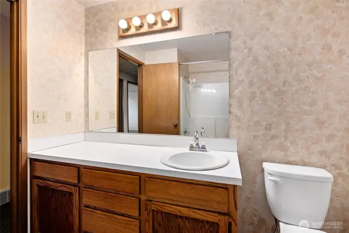 This is the main bath with shower and tub. Flooring in both bathrooms had Coretec Oak vinyl flooring installed in 2023.