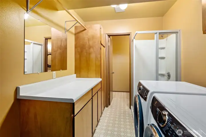 Laundry room with lots of storage and folding table.  2022 Electrolux Washer and Dryer convey with home.