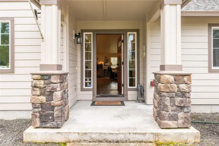 A lovely, covered porch with stone accent greets your guests!