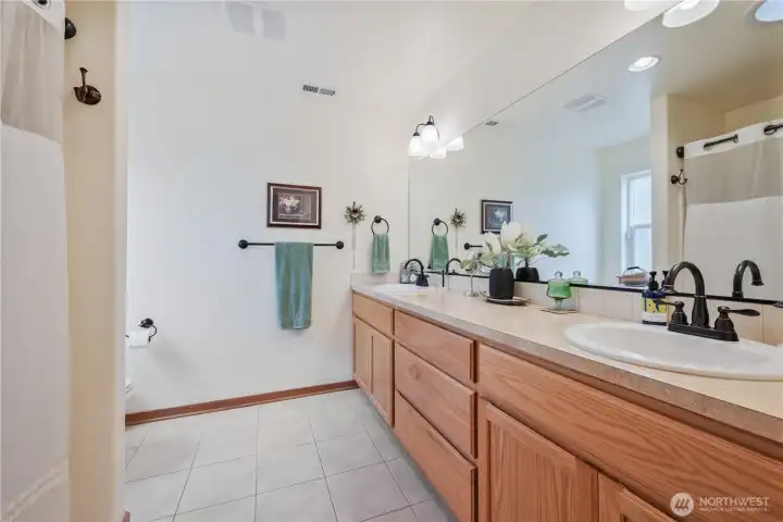 The primary bath is light and bright, with dual sinks.