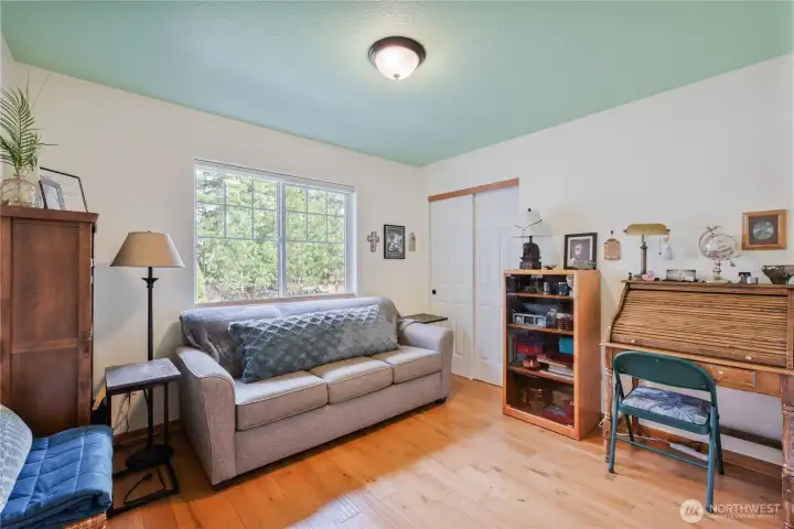 This secondary bedroom (used as an office with sofa bed by the owner) is conveniently located next to the main bathroom.