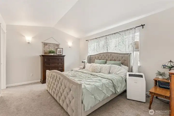 Upstairs Primary Suite, love the cathedral ceilings and large windows, nicely sized!