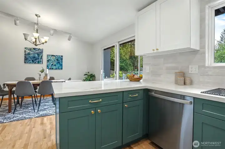 Open and bright kitchen opens onto dining area and deck