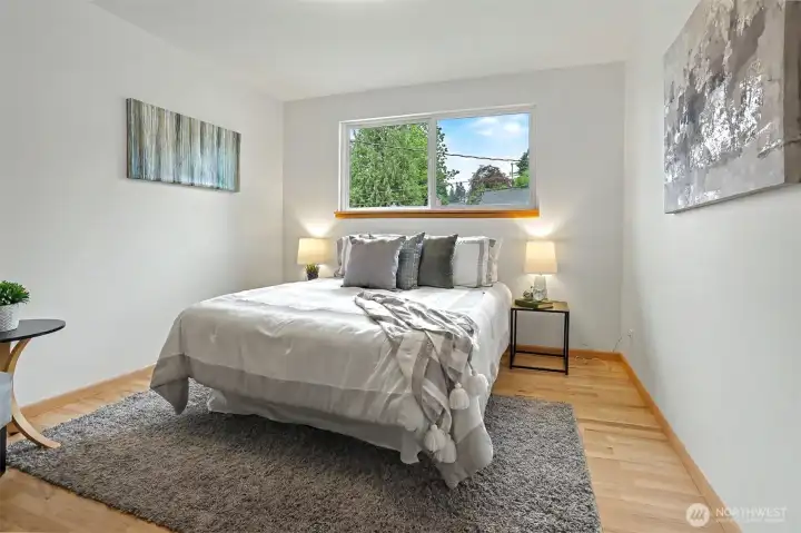 Second bedroom with gleaming hardwoods and  large window