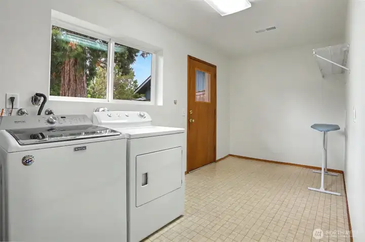 HUGE laundry and storage with rear yard access.