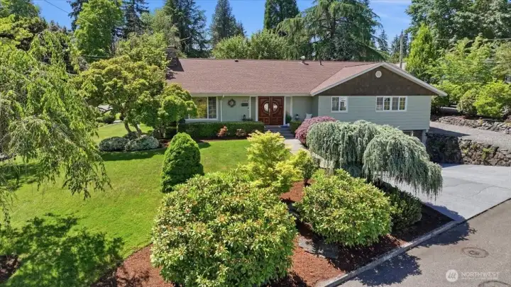 Beautifully landscaped front exterior of this updated 5-bedroom home in Fircrest, Washington, located on a quiet cul-de-sac.