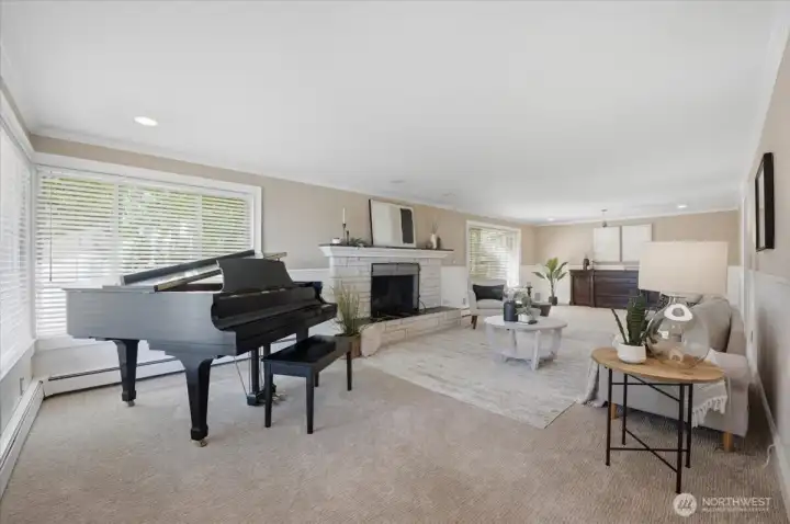 Spacious living room with fireplace, large picture windows, and abundant natural light.