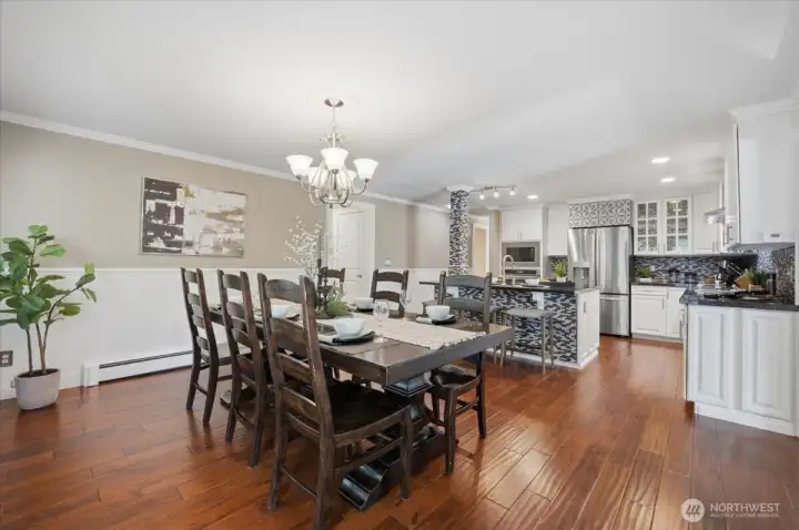 Formal dining room with hardwood floors and easy access to the kitchen.