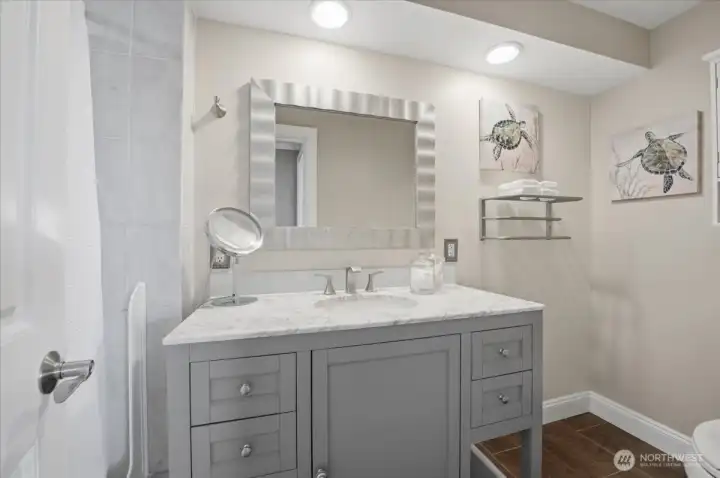 Beautifully renovated bathroom with modern vanity and contemporary finishes.