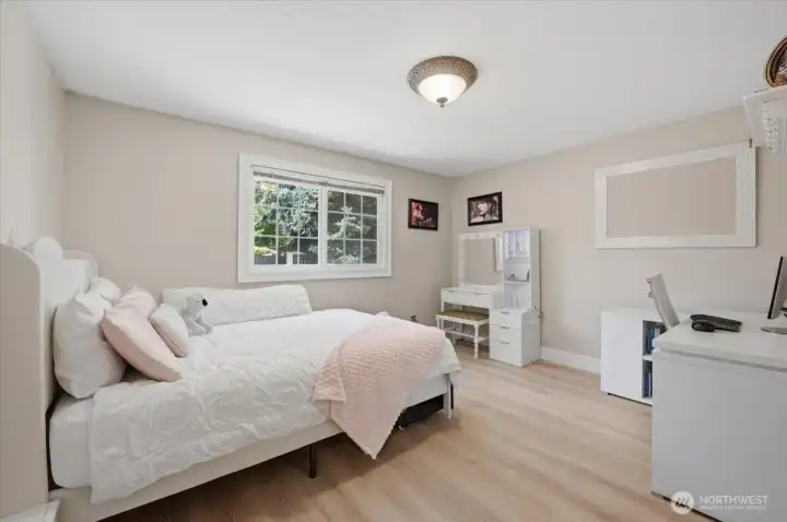 Comfortable guest bedroom with updated flooring and generous closet space.