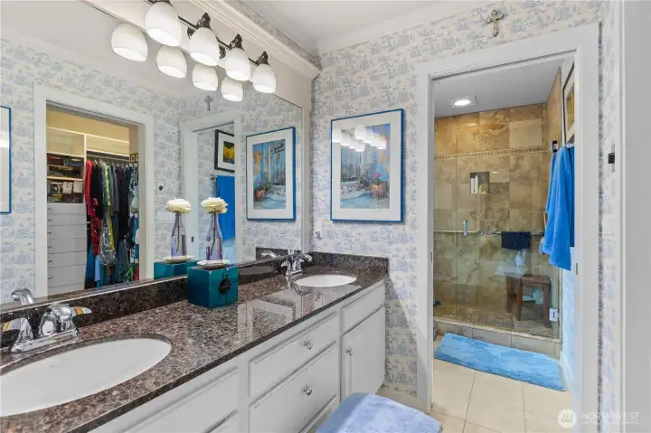 Primary bath with double sinks and granite counter.