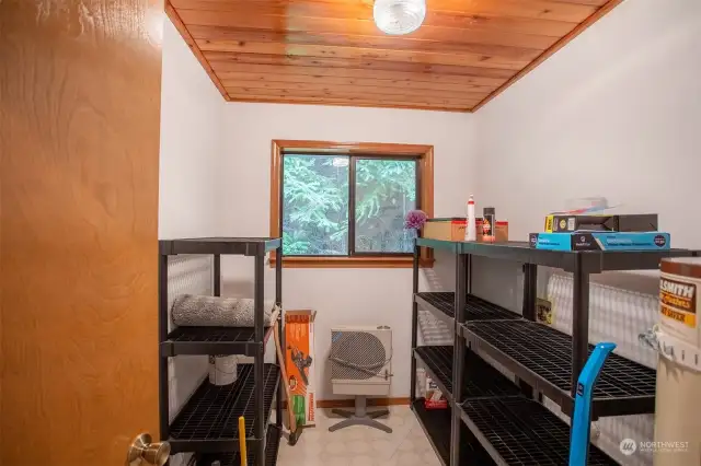 Utility room with water heater and hook ups for washer and dryer