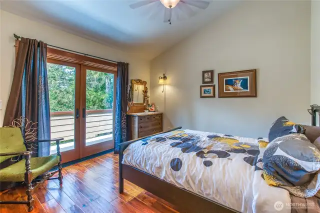 One of two guest bedrooms. French doors open up to private deck.