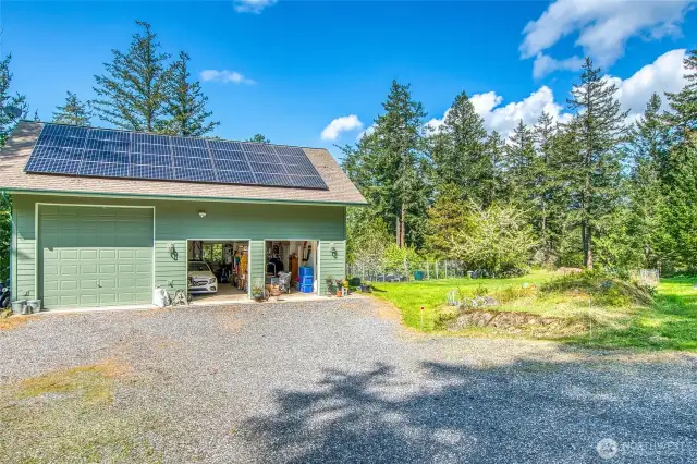 This property is set up to support island life! Solar panels, 2 car garage with large bay for RV, shop space and ADU (guest) studio above.