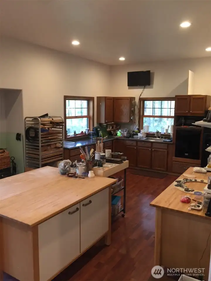 Lower basement space is used as an art studio with additional room as office. 3/4 bath with plenty of storage and separate entrance from the upper levels of the home.