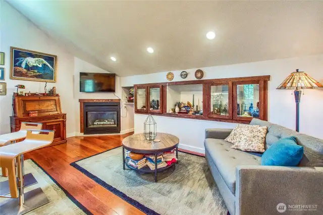 Living room in guest studio with built-ins and propane fireplace.