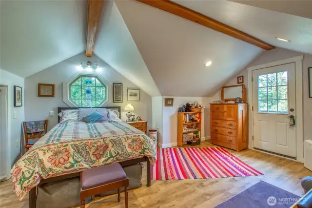 Bedroom in guest studio designed with vaulted ceiling and access to a private deck. NOTE: decks were just replace on the structure.