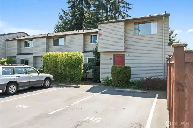 End unit with reserved parking space in front.