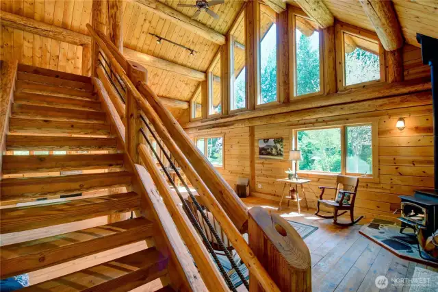 Stairway to loft and primary bed and bathroom.
