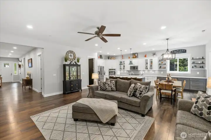 Massive great room features gourmet kitchen, LVP flooring, coffee bar area.  All open to extra wide slider door to the back and wide hallway to front.
