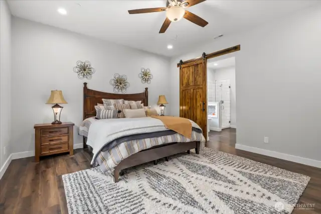 Primary bedroom with stylish custom sliding barn doors to 5pc bath.