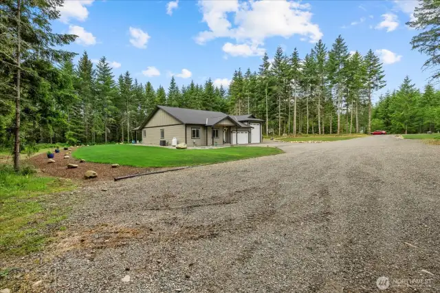View from corner of landscaped area shows the massive yard with so much space and beauty, but easy maintenance!