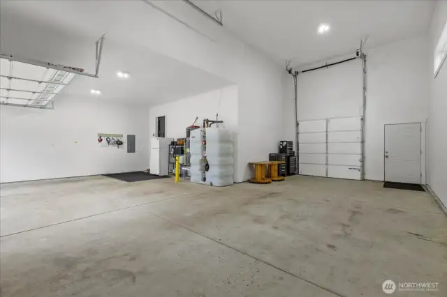 Massive garage features 2 car bay PLUS RV bay with 16' high garage door with 8' wide single garage door leading to back yard.  Room for all your toys with room to navigate through garage or on side.