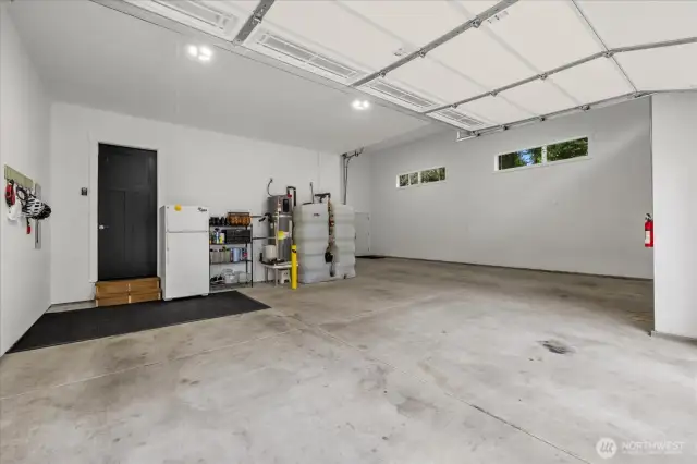 View from 2 car bay. Water heater and fire suppression water tank located here.  Right side is the RV bay with pull through access open to back yard. 200 amp electrical service to the home with generator hook up in the shed out back.