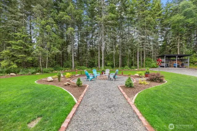 Walkway to the fire pit area.  Showing wooded area beyond and the 8x16' covered wood storage area.