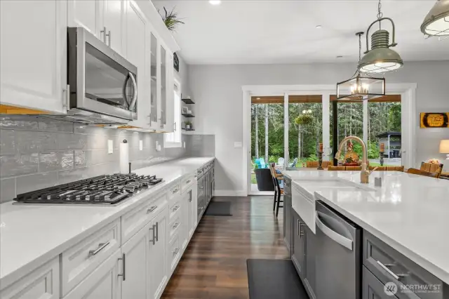 Entertainers dream kitchen features 5 burner gas stove, double oven, side by side fridge. All stainless steel appliances.