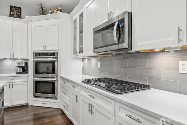 Double oven, 5 burner gas stove, built in microwave. All soft close cabinets with pull out shelving.